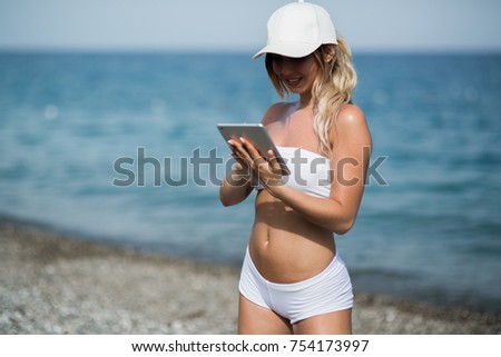 healthy gym blonde girl searches for new lifestyle fitness apps on her computer tablet.