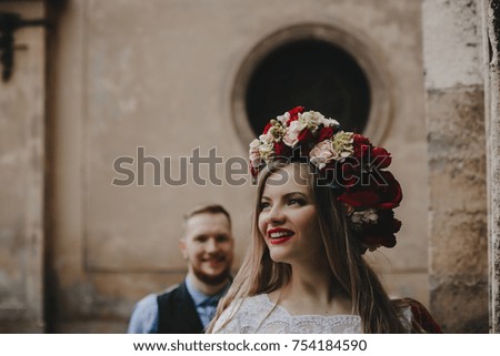 The beautiful girl has a wreath with flowers