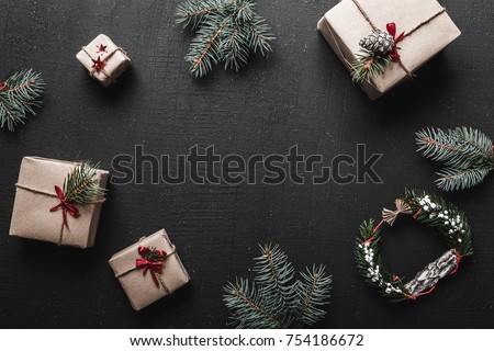 Christmas decoration, gift boxes and fir twigs, top view with copy space on black table surface. Xmas and other holidays concept Royalty-Free Stock Photo #754186672