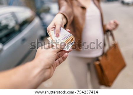 Corruption concept, man taking money from woman. Paying - hand giving euro banknotes to another hand. Money Loan. business woman and a businessman hold money. Woman giving money to a man. 