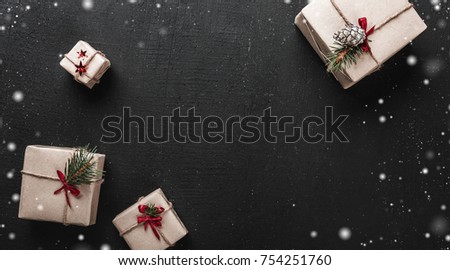 Christmas card. On black background, decorative gifts arranged in the corners keeping the center of the empty image for a greeting message Royalty-Free Stock Photo #754251760