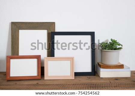 Set of Frame photo with book and houseplant on wooden table.home decor