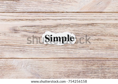 Simple of the word on paper. concept. Words of Simple on a wooden background.