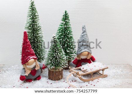 Christmas festive card with gnome,fir tree,sledge and snow.
