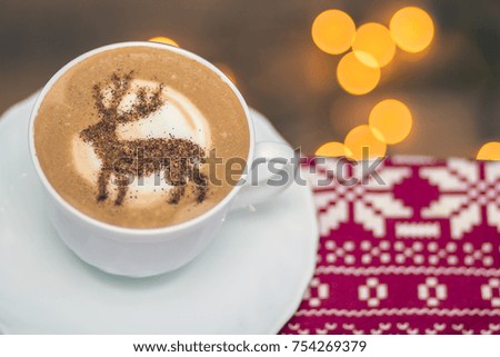 background of Christmas coffee sweet cappuccino with a picture of a deer from cinnamon on a luscious milk foam