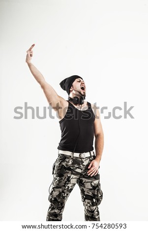 charismatic DJ - rapper with headphones on a light background.the photo has a empty space for your text