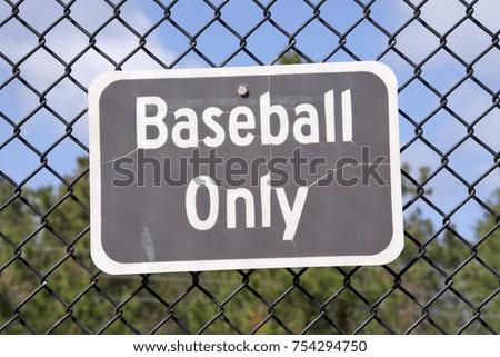 baseball only sign on fence centered