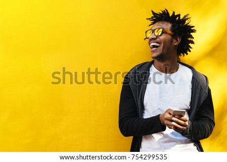 Portrait of handsome afro man using his mobile. Royalty-Free Stock Photo #754299535
