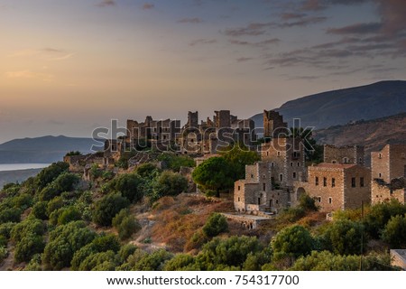 Amazing colorful sunset over the architectural and historical towers dominating the area at the famous Vatheia village in the Laconian Mani peninsula. Laconia prefecture, Peloponnese, Greece, Europe.