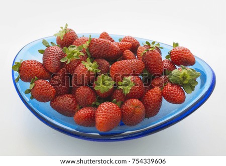 Strawberries in blue glass bowl