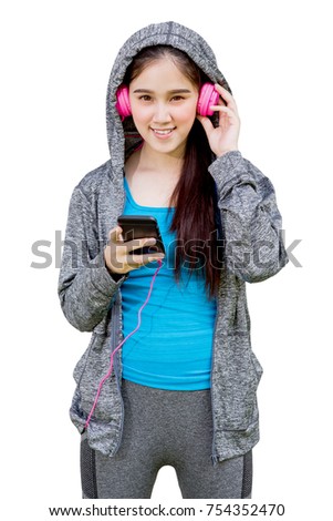 Portrait of beautiful girl in hood with smart phone listening to music from headphones