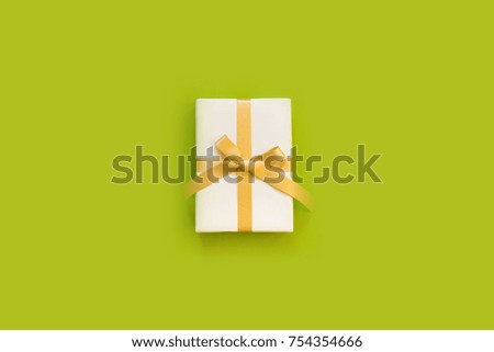 Gift for New Year or birthday. View from above. Bright green background.