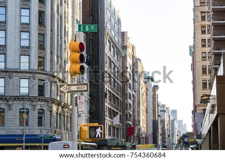 View of crowded city streets looking down Broadway from the intersection of 8th Street in Manhattan, New York City NYC