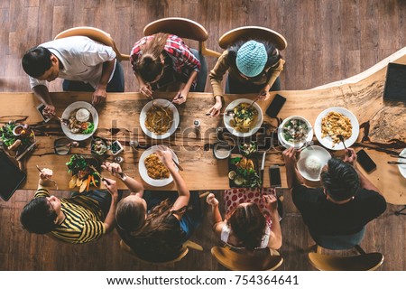 Group of happy friends having nice food and drinks, enjoying the party and communication, Top view of Family gathering together at home for eating dinner. Royalty-Free Stock Photo #754364641