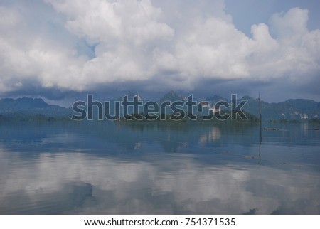 a lack landscape picture with reflection of clound