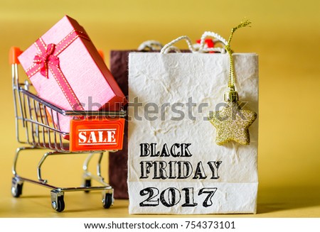 Soft focus mini shopping cart and shopping bags with label tags ,Black Friday sale concept.