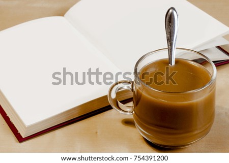 Obogrevala mug of coffee and a book