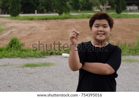 asia boy wearing black T shirt  in garden and face expression like happy, sad, angry, surprise