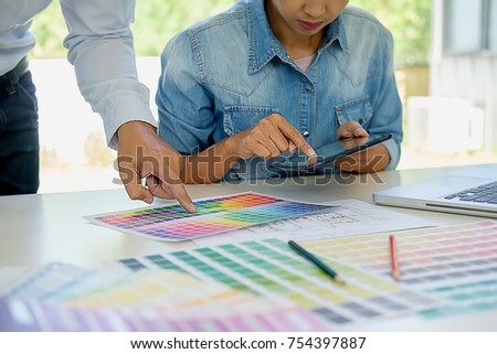 Graphic design and color swatches and pens on a desk. Architectural drawing with work tools and accessories