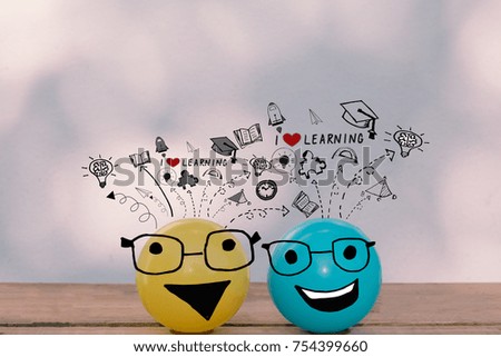 Happy smiley yellow ball and blue ball wearing glasses with education and learning doodles - I love learning concept