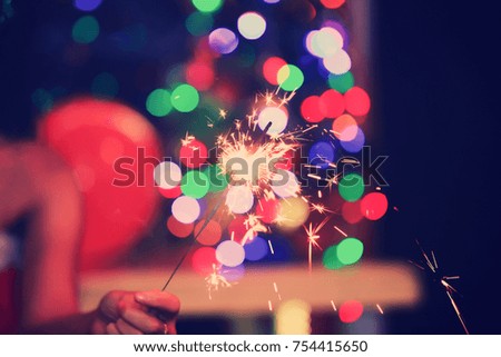 Fire sparkler with colorful Bokeh background 