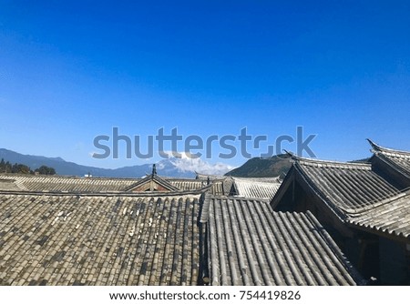 snow capped view of jade mountain  from roof top lijiang town 