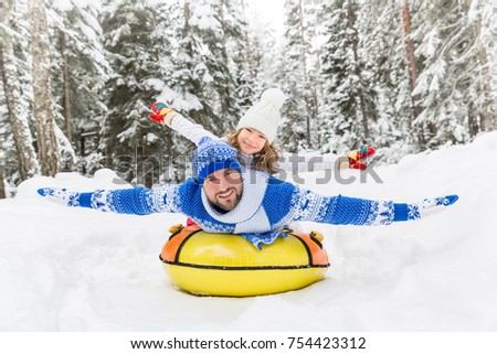 Happy family having fun outdoor. Child and father playing in winter time. Active healthy lifestyle concept