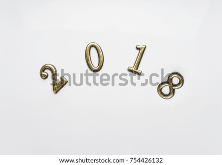 2018 new year background gold numbers on white. Top view, close-up. Festive greeting card with copy spase