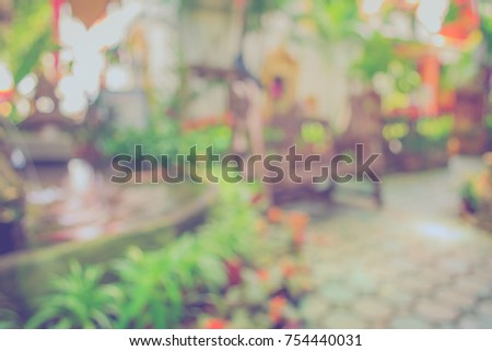 image of Abstract blurred outdoor coffee hut in garden on day time for background usage . (vintage tone)
