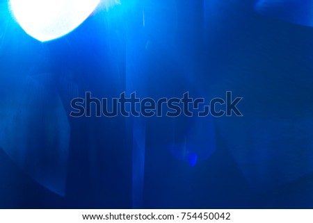 The blue spot of light on the dark background. anamorphic lens shot
