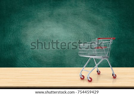 Shopping cart red on wood table with black board backdrop. Ideas about online shopping, E-commerce and global network online business. copy space for art work design or add text message.
