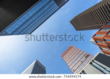 Perspective and directly below view of modern highrise
