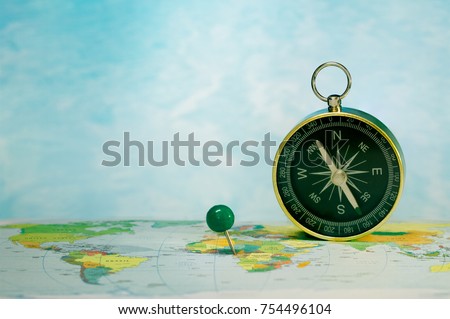 Magnetic compass on world map, concept of travel and destination, macro travel
