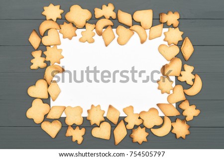 Gingerbread cookies on white background. Heart, star, bear, moon shapes. Christmas cookies on wooden surface