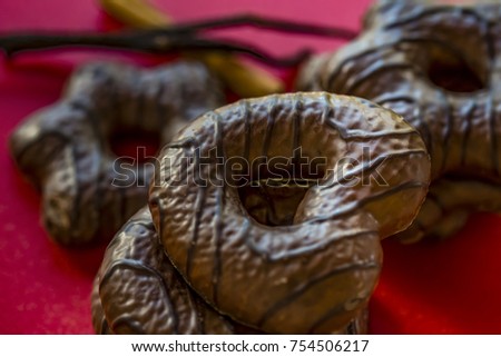 Chocolate covered sweet cookies, Christmas treats, red background.
Lebkuchen, traditional German Christmas baked gingerbread biscuits.
 Royalty-Free Stock Photo #754506217