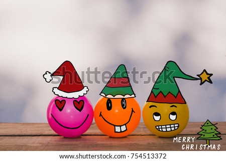 Smiley face yellow ball, pink ball and orange ball with Christmas doodles