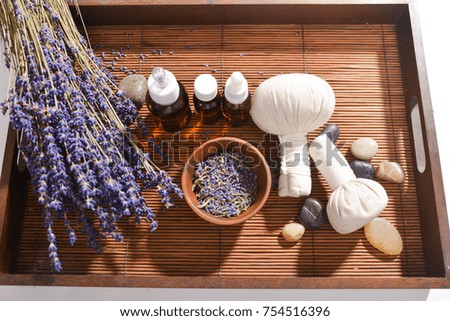 lavender with herbal ball.,black stones ,oil, petals in bowl in wooden basket
