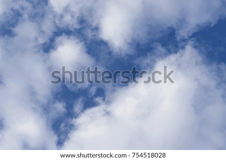 Fluffy white cumulus clouds on blue sky, background, close-up