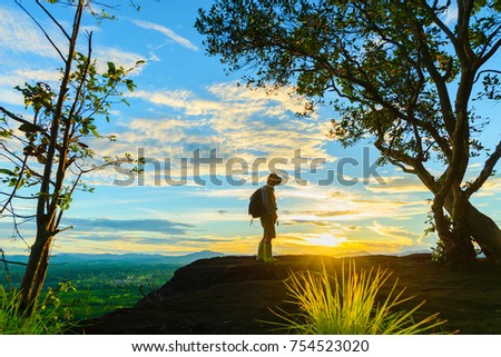 backpacker man travel alone, posing on top of mountain  