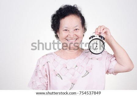 Asian Senior woman with alarm clock