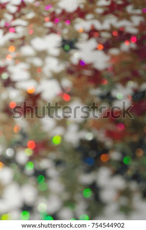 Colorful defocused glowing lights amidst festive decorations /Blurry Abstract Festive Background / Ideal for Christmas,New Year,Chinese New Year and Hari Raya Aidilfitri celebration background