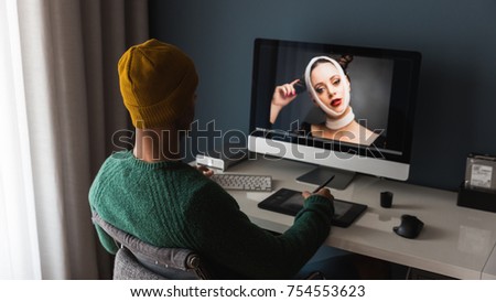 Man working at home editing pictures on computer