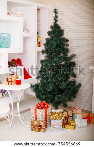 Christmas is not decorated with a Christmas tree with gifts under it against a white brick wall. Concept of holidays. Royalty-Free Stock Photo #754556869