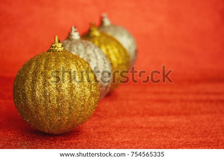 Four gold and silver Christmas toy on a red background . New Year, christmas background.
