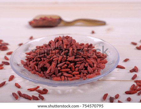 Goji berries in transparent glass bowl with goji berries on the table