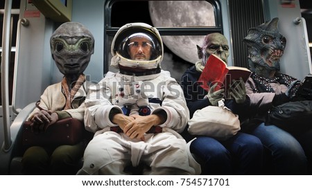 On a spaceship, an astronaut, sitting alongside extraterrestrial monsters, travel in total relaxation reading a book. Concept of space transport, surrealism, future, new worlds. Royalty-Free Stock Photo #754571701