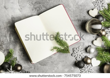 Open Empty Notebook for New Year's Resolutions in Xmas Settings with Pine Branches and Decorations on Grey Background. Top View, Space for text