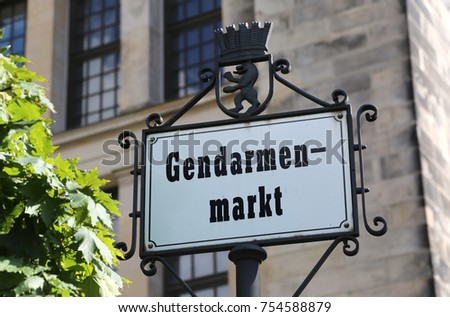 main square of Berlin in the road sign called Gendarmenmarkt that means Market of Soldiers