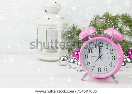 Alarm clock and Christmas decorations on a white vintage background