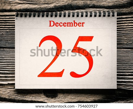 December 25 in the calendar on the wood background 